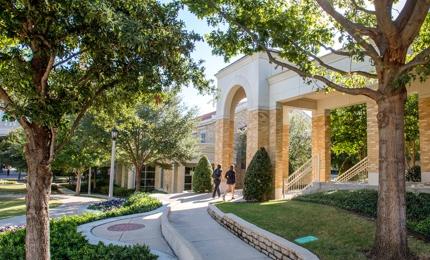 Two Female students walking through the commons buildings